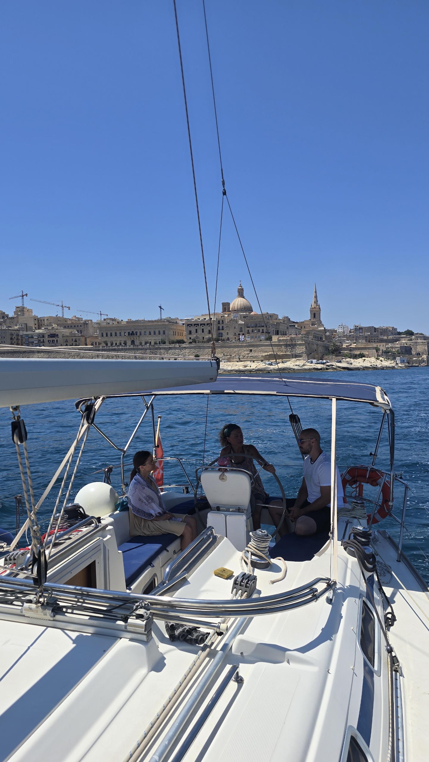 Guests at the helm with Valletta in the background
